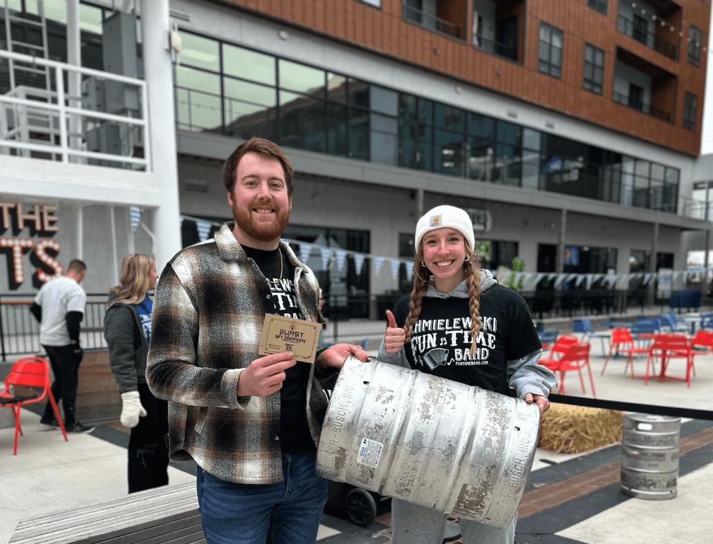 Two event attendees enjoying West Fargo Events with branded event merchandise